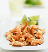 Prawns with lime wedges and herbs