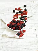 Fresh summer berries in and next to a bowl