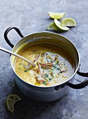 Curry soup with lime and herbs