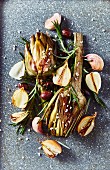 Oven-roasted artichokes with garlic, onions, olives and rosemary
