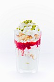 Frozen yoghurt with vanilla cake, meringue, raspberry purée, pistachios and cream