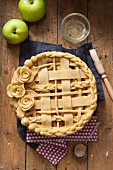 Apple pie with a dough lattice and roses