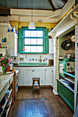Rustic kitchen with a green color accent