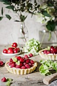 A cherry and raspberry tart on a kitchen table.