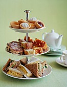 Pastries and sandwiches on a stand for afternoon tea