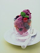 Berry ice cream with fresh blueberries and raspberries in a dessert glass