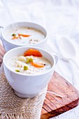 Pot pie soup served with chicken and vegetables in cups