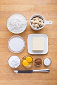 Ingredients for making macadamia and cinnamon biscuits with icing sugar