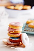A stack of mini doughnuts with different sugar glazes