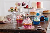 Different cupcakes, small pastries and cakes on a wooden table