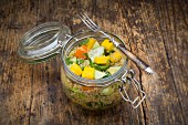 Quinoa salad with avocado, cucumber, tomato and mango in a glass jar