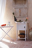 Summer atmosphere: fruit, drinks and flowers on tray table and cabinet in Mediterranean room