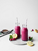 Pink liquorice and raspberry smoothie served in glass bottles