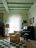 Piano and armchair in traditional music room