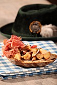 Bavarian pretzel salad with raw ham on farmhouse bread
