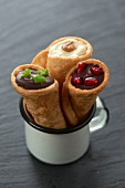 Filled tortilla cones with chilli chocolate, white chocolate with walnut and dark chocolate with pomegranate seeds (Mexico)