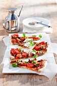 Slices of pizza with cherry tomatoes and tuna