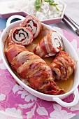 Chicken roulade wrapped in bacon filled with pepper and spinach