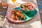 Grilled chicken kebabs with a radish salad