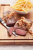 Fried rump steak with onions and fries