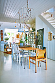 Open dining area with vintage furniture next to the stairs