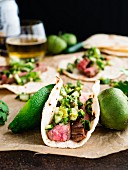 Tacos with flank steak, Pico de Gallo Verde, limes and tomatoes