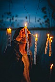 Woman lighting candles outside