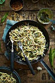 Wild garlic pesto spaghetti in pan with pamesan