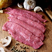 Veal cutlets on cutting board for Scaloppine