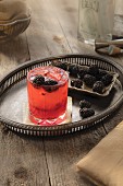 Blackberry beer cocktail on a silver tray