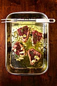 Lamb chops in olive oil marinade with garlic and rosemary