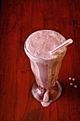 Strawberry milk shake on a red background