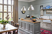 Country-house kitchen-dining room with dining table and lattice window