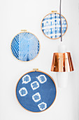 Hand-made wall decorations made from embroidery rings and old handkerchiefs hand-dyed using Shibori technique
