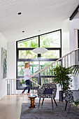 Armchairs and side table in front of stairs