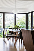 View of an elegant dining area in front of a window in an open living room