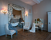 Baroque furniture in historical bathroom with bathtub in niche