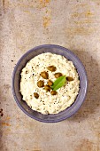 Tartare sauce in a small bowl on a stone background