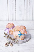 Two baked Easter lambs with a sugar glaze and colourful ribbons