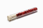 Red peppercorns in a test tube