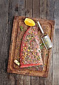 Fresh salmon with herbs, orange and spices