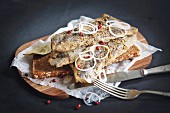 Baltic herring with pepper and onion on bread