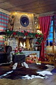Festively decorated fireplace in comfortable chalet living room