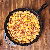 Tater tots with bacon and egg in a pan (USA)