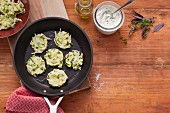 Courgette fritters in a pan