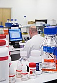 Reagent bottles on a laboratory shelf