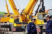 Workers on site with construction vehicles