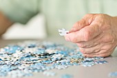 Senior man doing a jigsaw puzzle