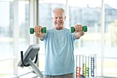 Senior man using weights