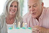 Senior couple with birthday cake